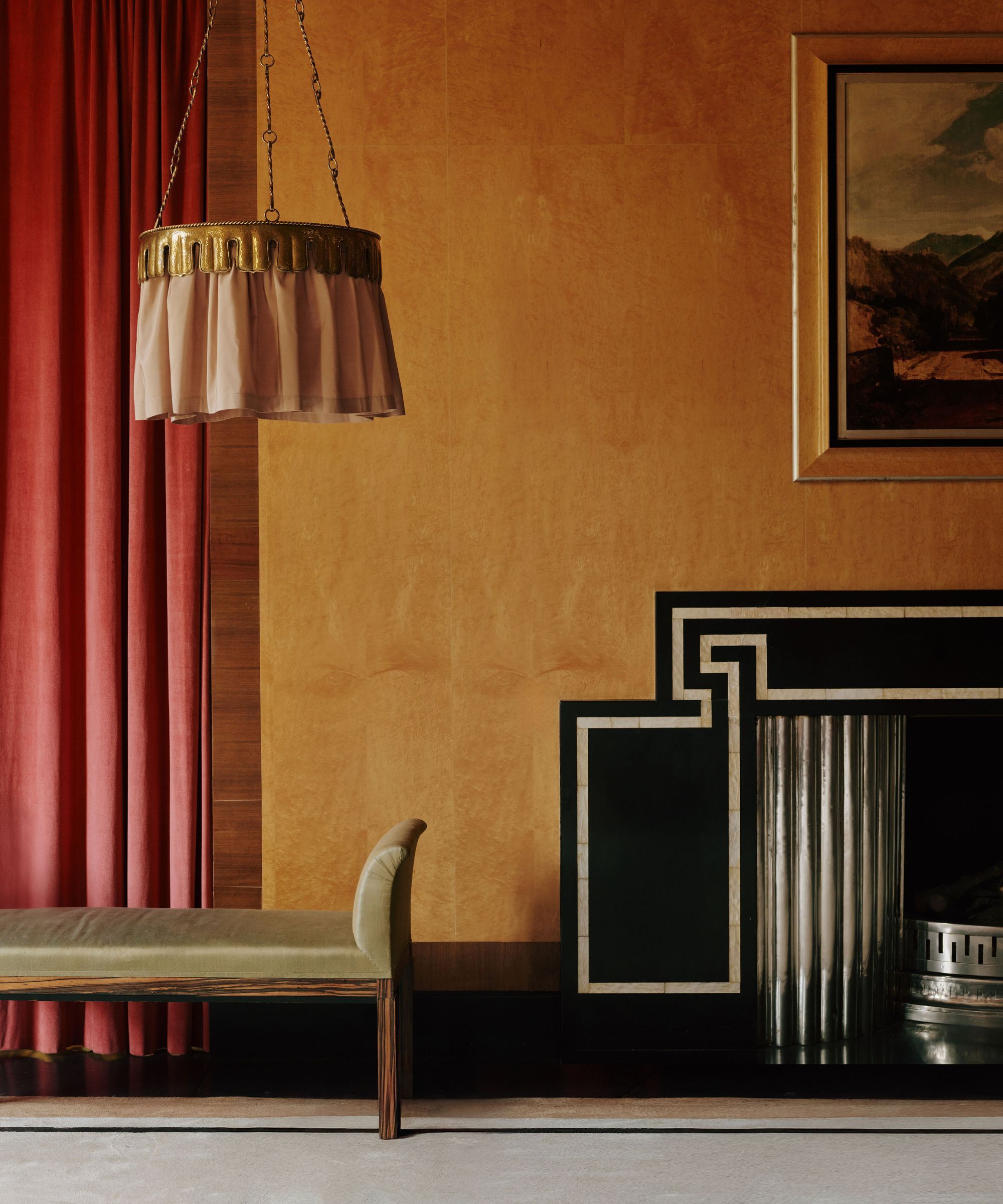 A ceiling light with a metal rim and a dusky pink fabric shade