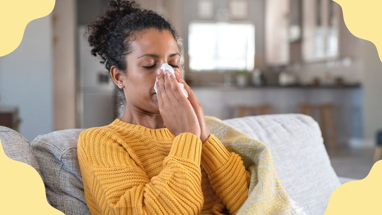 woman with allergies blowing her nose