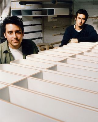 A 1990s portrait of designers Edward Barber and Jay Osgerby with early models of the Loop Table
