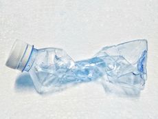 Twisted water bottle in the snow.