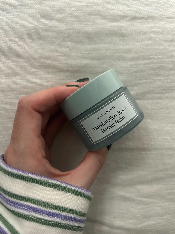 Junior beauty editor Grace Lindsay holding the Naturium Marshmallow Root Barrier Balm