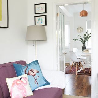living area with sofa with flamingo print cushions