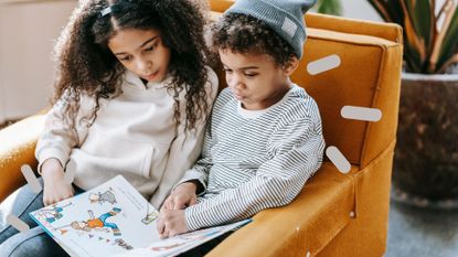 Two kids sat together reading