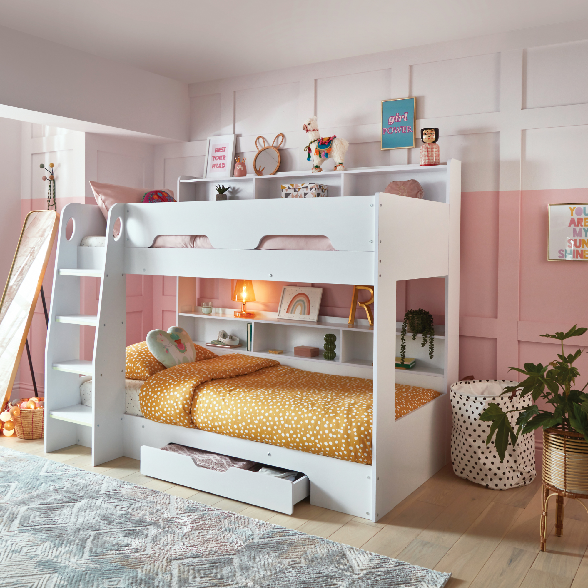 a kids room with white bunk bed and pink and white painted panelled wall 