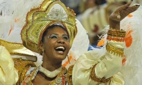 A dancer parades during Rio de Janeiro&amp;#039;s annual Carnival, which is expected to draw 756,000 people from across the globe.