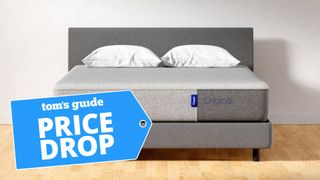 Image shows the Casper Original mattress in a box on a grey bed frame with a blue Price Drop sales badge overlaid in blue