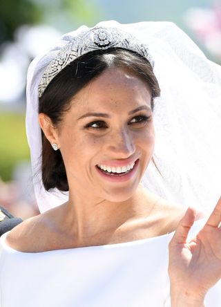Meghan, Duchess of Sussex leaves Windsor Castle in the Ascot Landau carriage during a procession after getting married at St Georges Chapel on May 19, 2018 in Windsor, England