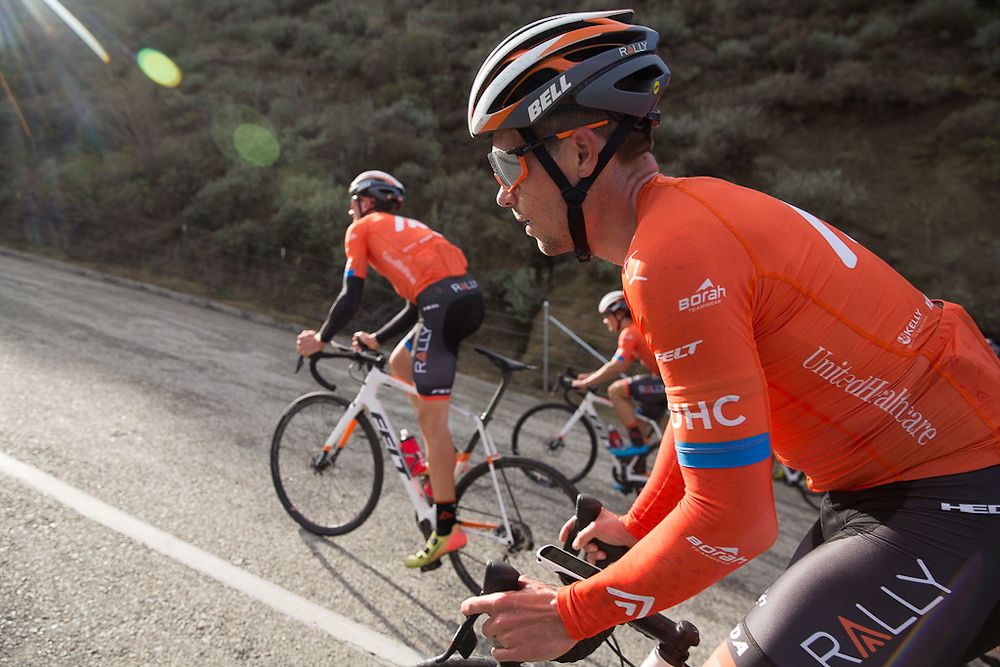 Evan Huffman climbs into the sun rays on a Rally UHC training ride