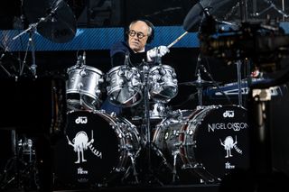 Olsson plays the drum whilst wearing a pair of FootJoy gloves