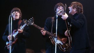 George Harrison (1943-2001), Paul McCartney and John Lennon (1940-1980) of The Beatles perform at Empire Pool in Wembley at the New Musical Express Annual Poll Winner's Concert in what would be their final scheduled performance in Britain, May 1, 196