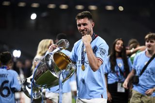 Aymeric Laporte celebrates with the Champions League trophy after Manchester City's 1-0 win over Inter in June 2023.