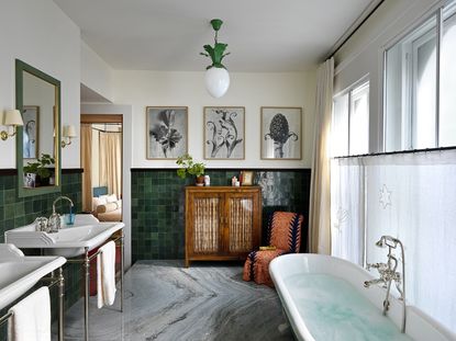 modern bathroom with green tiles marble floor and art on the walls