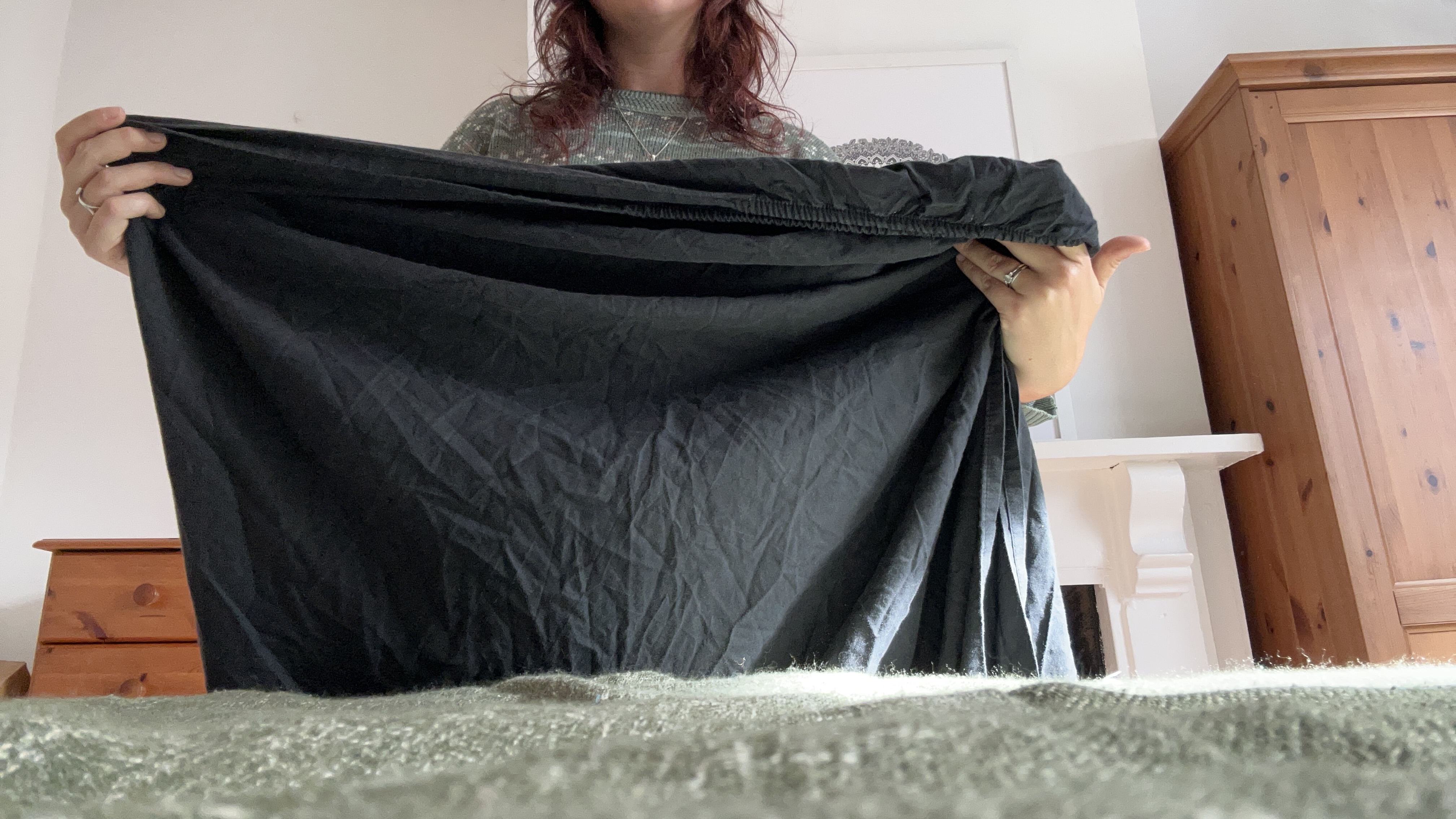 The Tom's Guide Sleep Features Editor folding the corners of a fitted sheet