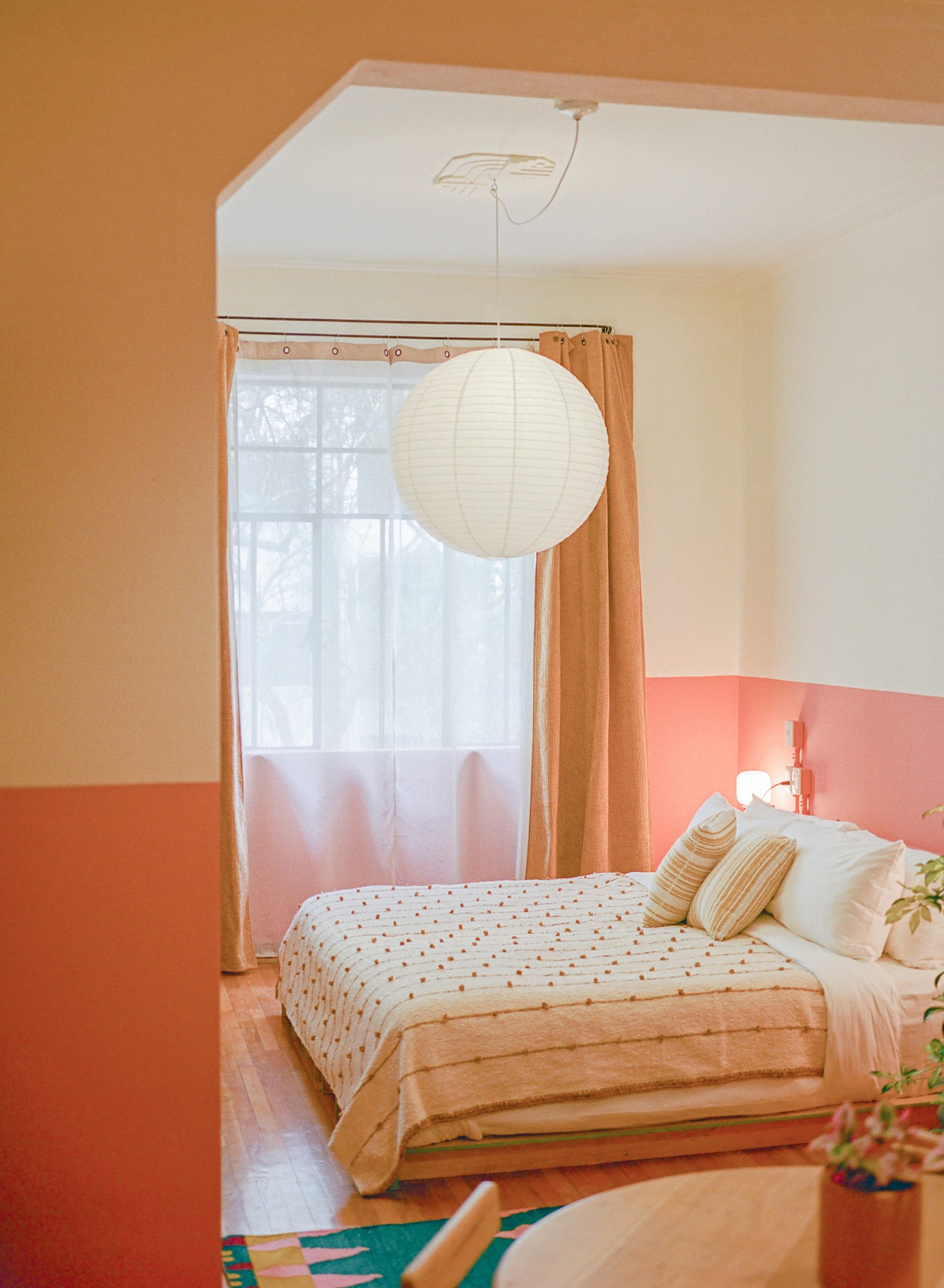 A vibrantly decorated hotel featuring a pastel palette of pinks, greens, and browns, tiled surfaces, and a vaguely Art Deco, contemporary feel.
