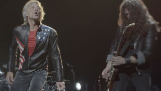 Jon Bon Jovi smiling during a concert in Thank you, Goodnight: The Bon Jovi Story.