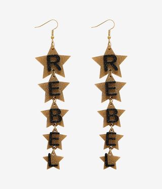 Gold star earrings with Rebel written on them.