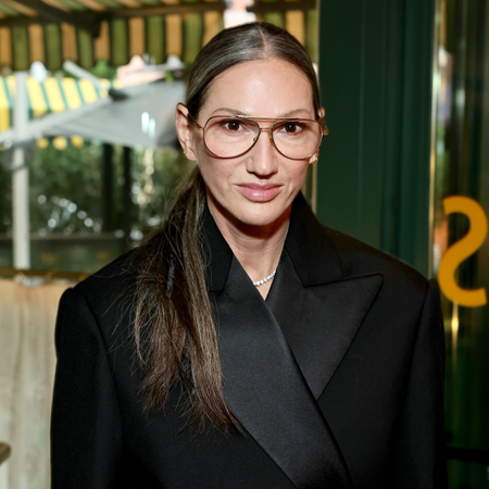 Jenna Lyons wearing glasses and a low ponytail 