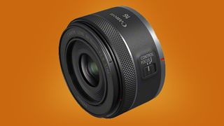 The Canon RF 16mm F1.8 STM on an orange background