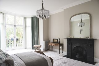 black period fireplace in a white modern bedroom