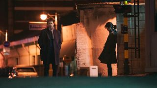 two people (Lee Sung-kyun and IU) stand in a dark alley, in Netflix k-drama 'My Mister'