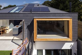 grey self build with solar pv panels on roof
