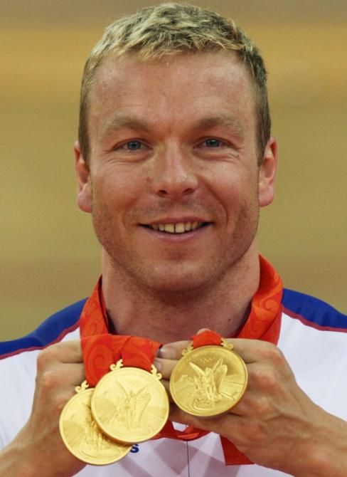 Chris Hoy poses for pictures on August 19, 2008 with the gold medals won during the 2008 Beijing Olympic Games