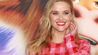 Reese Witherspoon wearing subtle pink eyeshadow with a bright red lipstick