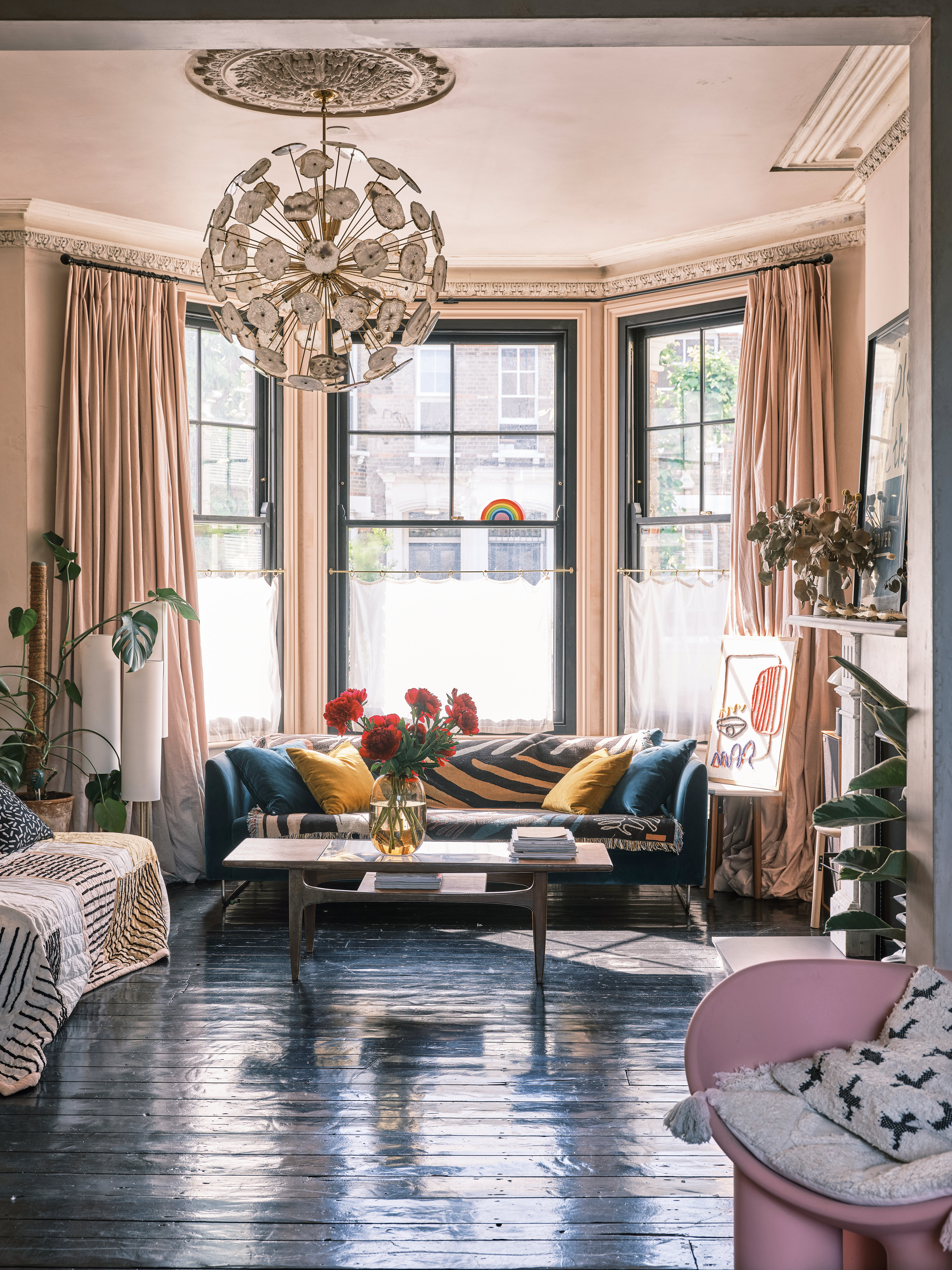 Pink living room with painted black flooring