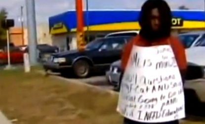 A Florida mother whose son earned a woeful 1.222 GPA is making him stand on the sidewalk wearing a sign that says "Honk if I need [an] education."
