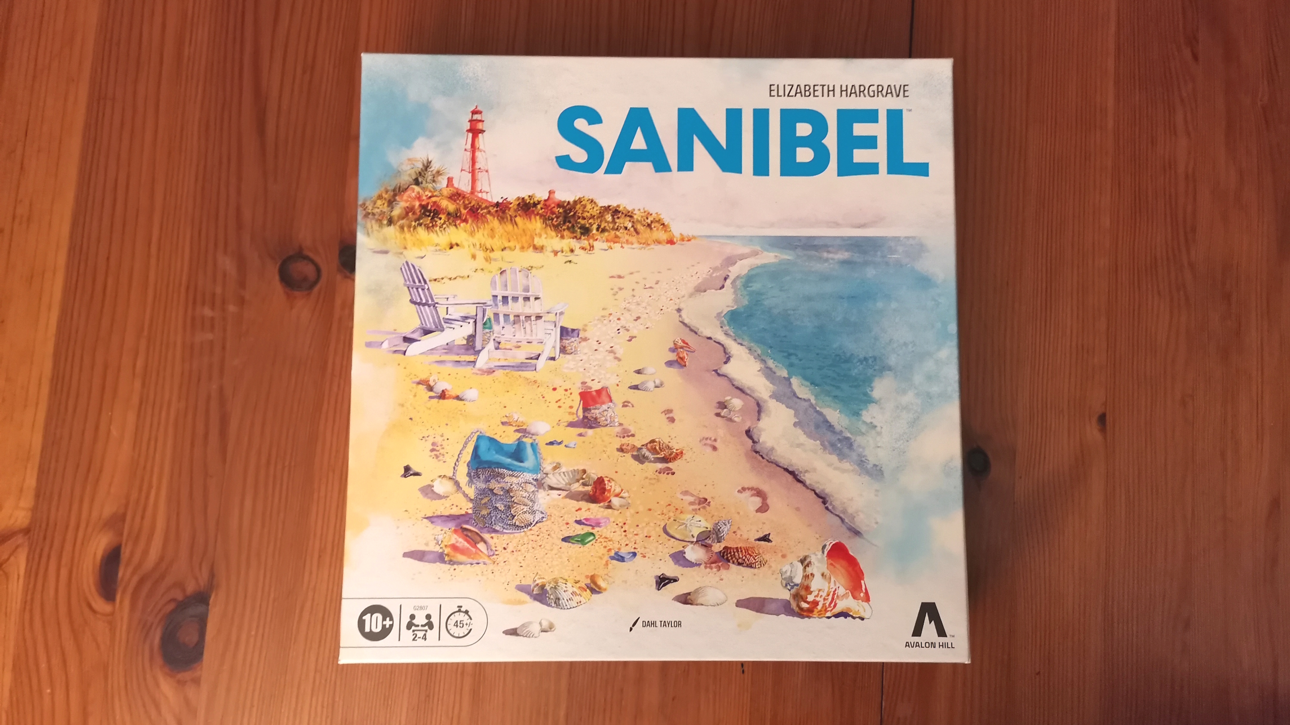Sanibel board, tokens, and pieces on a wooden surface
