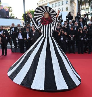 British model Ikram Abdi Omar arrives for the Closing Ceremony and the screening of the film "Elemental" during the 76th Cannes Film Festival.
