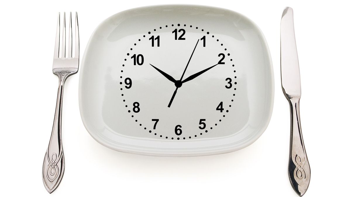 Dishware and clock. Concept restrictions in food.