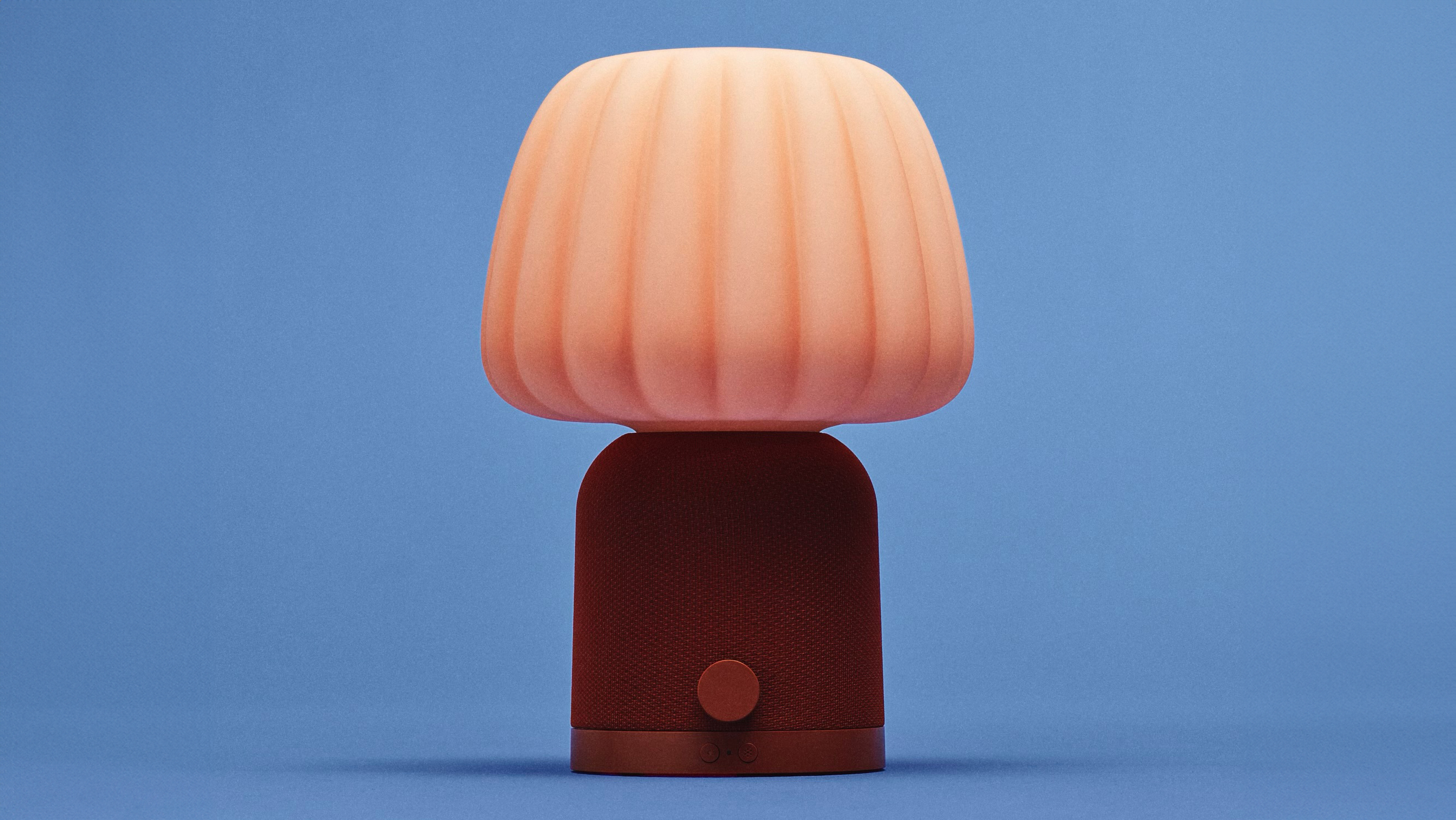 Two IKEA speaker lamps on a blue background