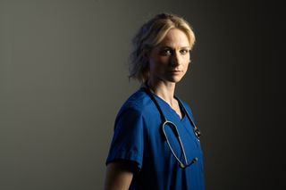 Malpractice cast: Niamh Algar as Dr Lucinda Edwards wearing a stethoscope and blue scrubs