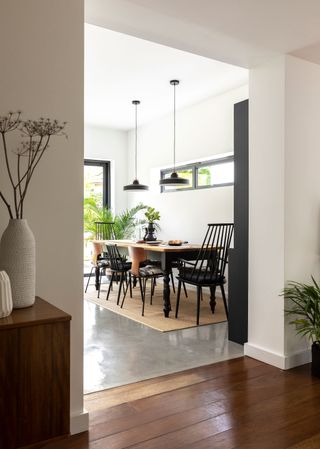 An extended bungalow in a mid-century monochrome style with large dining table