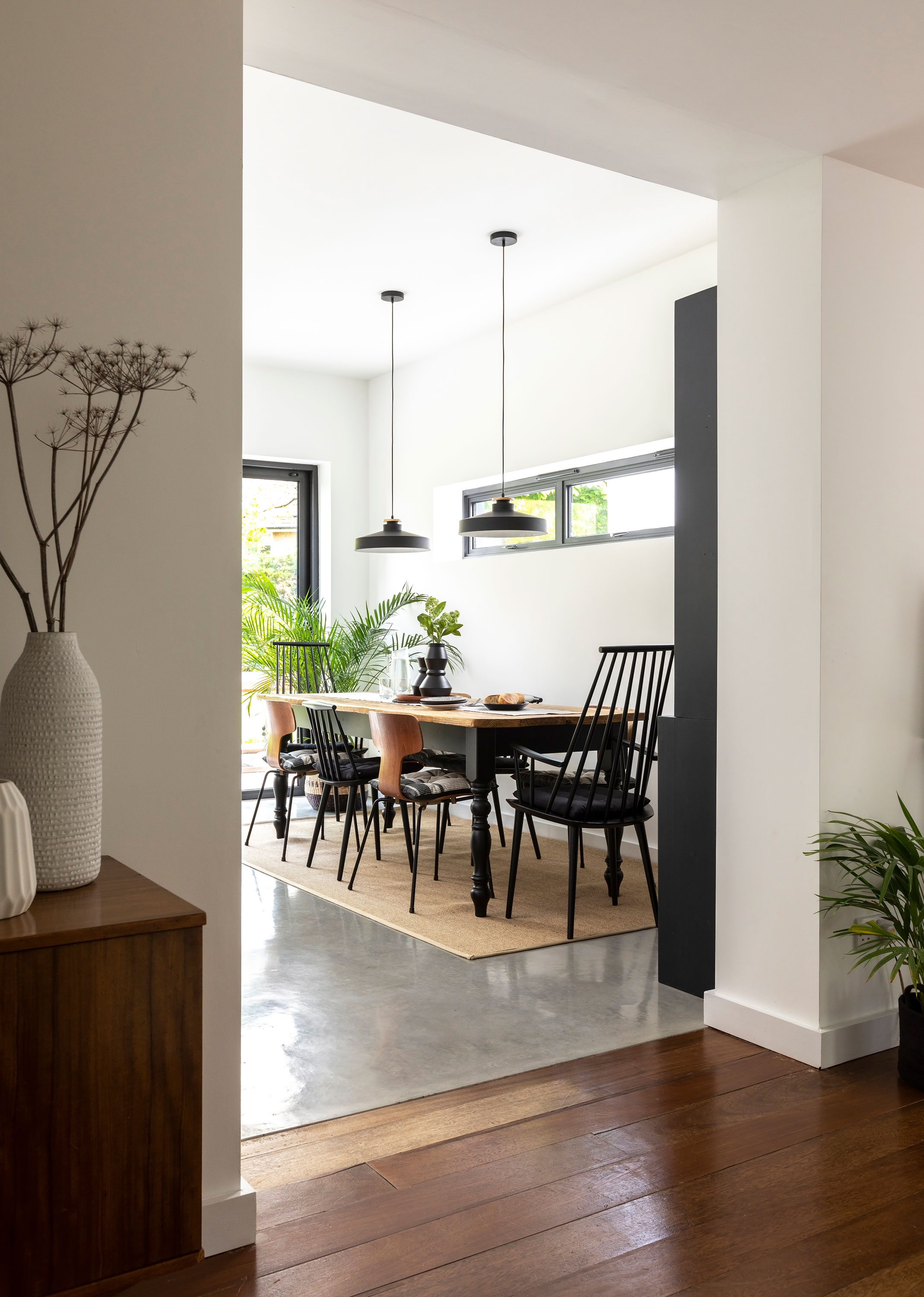 An extended bungalow in a mid-century monochrome style with large dining table