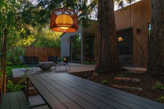 a backyard deck with warm lighting