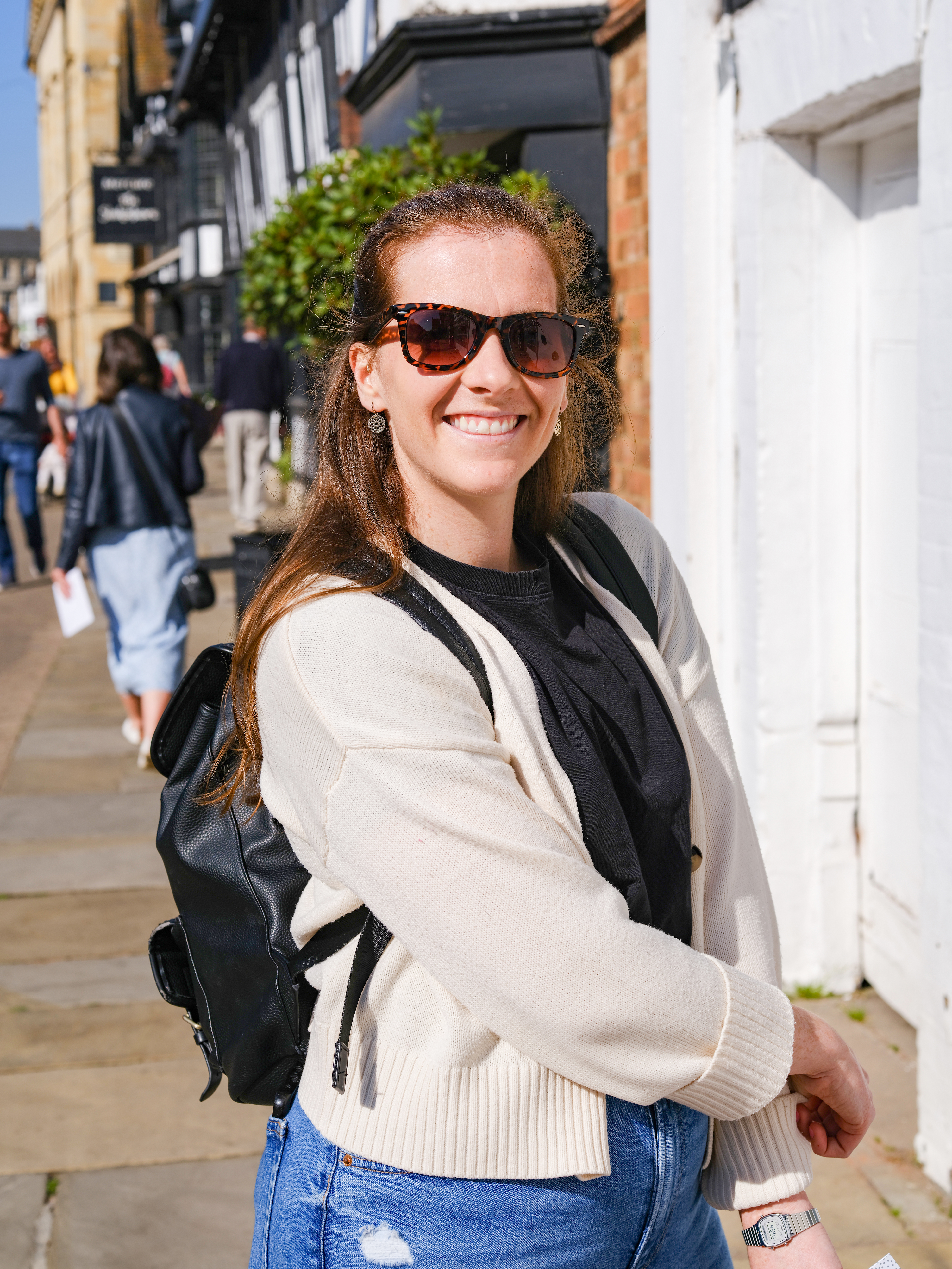 A photo of a woman smiling. Taken on the Fujifilm GFX100 II.