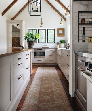 kitchen with kitchen rug and beams