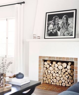 white living room with large family photo on the mantle piece