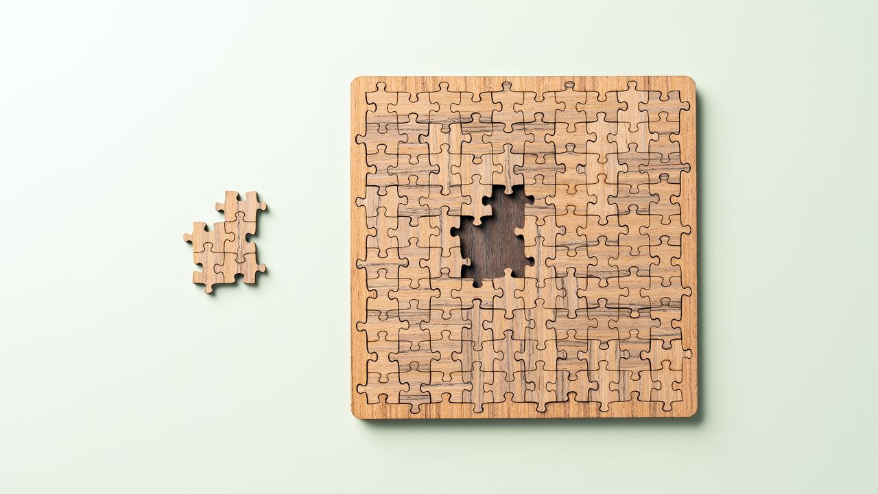 wooden puzzle with missing pieces set to the side