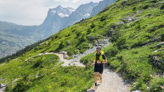 Ultra runner Jake Catterall running above Grindelwald in the Swiss Alps