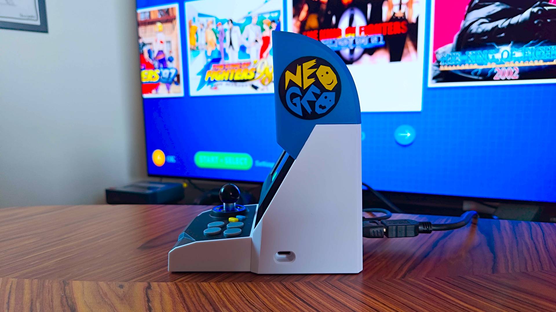 Side view of Neo Geo Mini with USB-C port in view and HDMI connected into back.