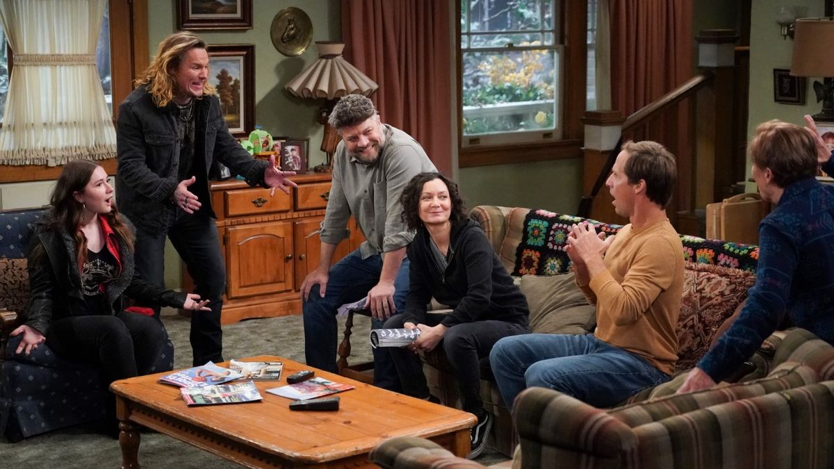 Ben and Darlene smiling in living room on The Conners