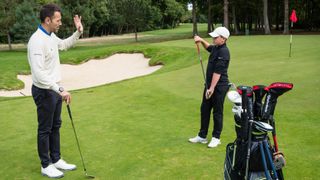 Nick Dougherty and young Golf Monthly reader Josh Jackson discussing a short game drill at Wentworth