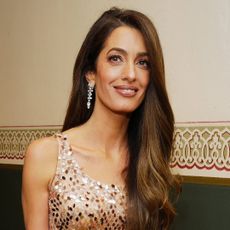 Amal Clooney was spotted in Lake Como wearing a cowl-neck magenta gown