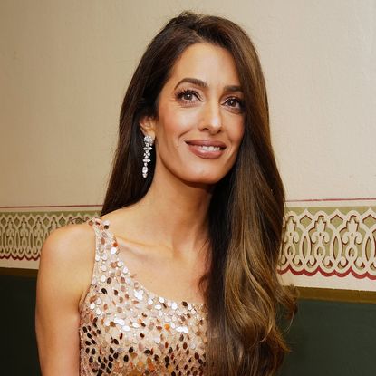 Amal Clooney was spotted in Lake Como wearing a cowl-neck magenta gown