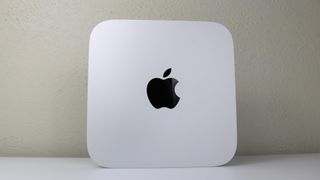 A Mac mini M2 upright on a desk