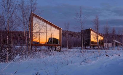 An outside view of a the cabins at Arctic Bath — Lapland, Sweden