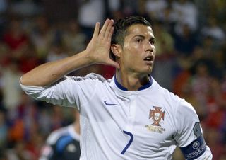 Cristiano Ronaldo cups his ear as he celebrates after scoring for Portugal against Armenia in June 2015.